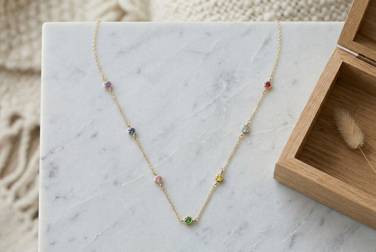 18K gold anchor chain necklace with multicoloured tuttifrutti zirconia stones on marble – lifestyle photo