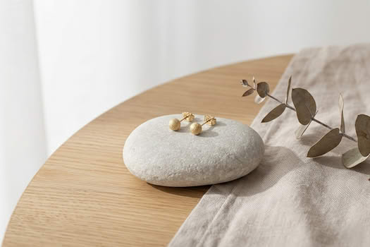 18K gold frosted ball stud earrings on stone, lifestyle photo