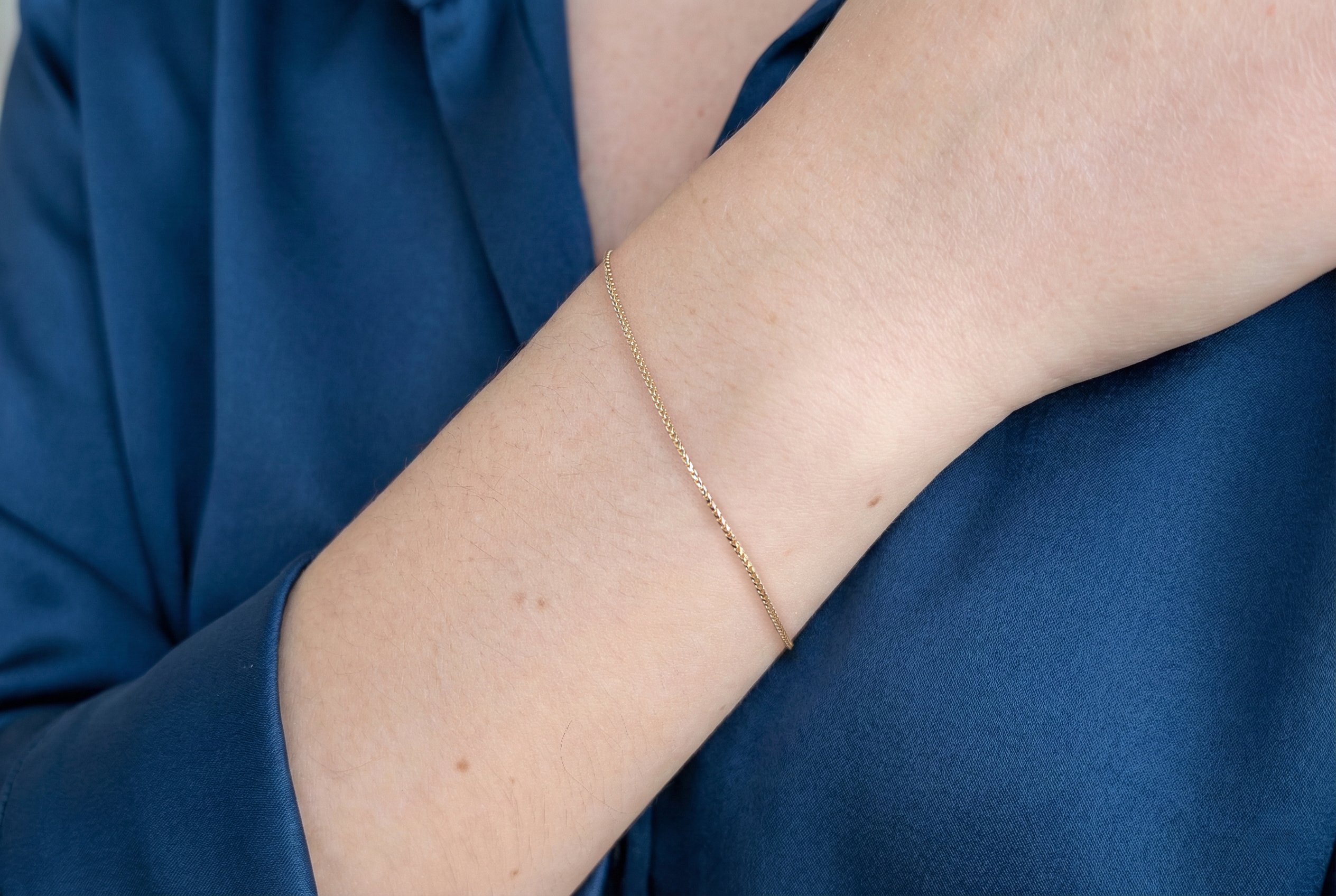 Thin 18K gold Franco chain bracelet on model – real gold women's jewelry